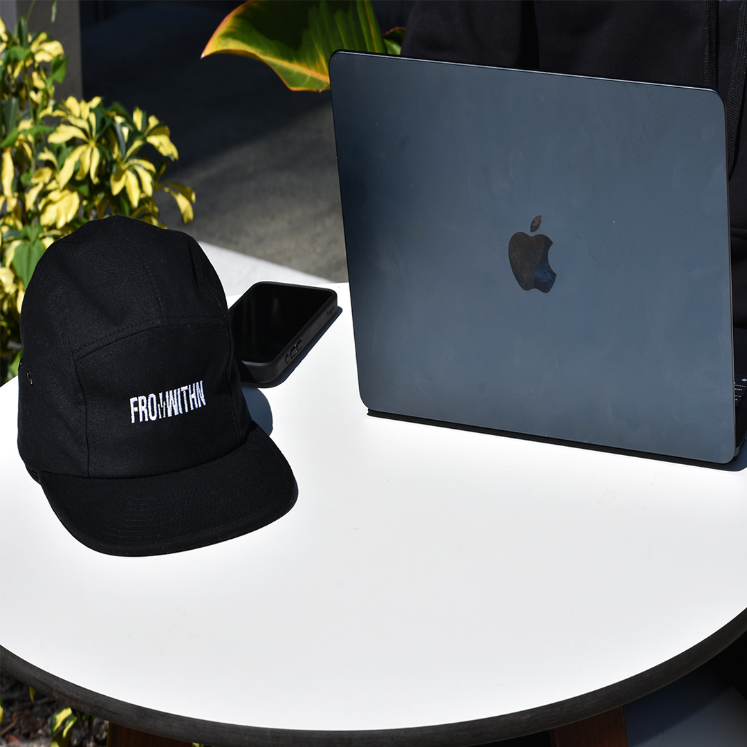 From Withn Strapback Cap Lifestyle Picture with iPhone 15 Pro Max and Macbook Air